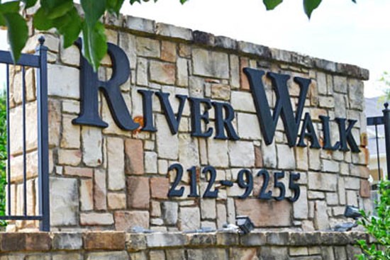 Riverwalk beautiful stone front sign with black letters and phone number