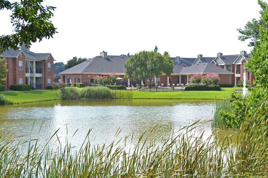 Champion Lake Apartments Backside View From Lake Looking Into Apartment Complex