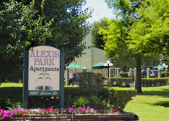 Alexis Park Apartment green and purple front sign in Bossier