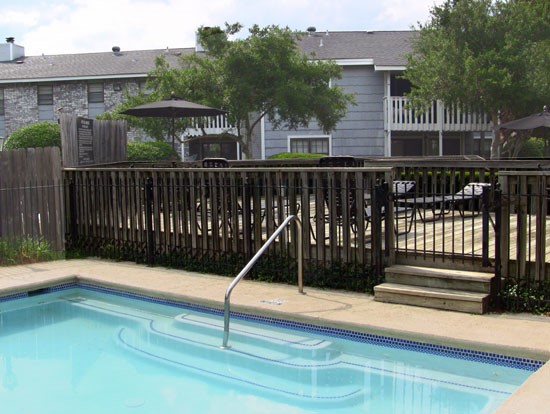 Pier Landing outside gated pool with steps and railing leading into pool