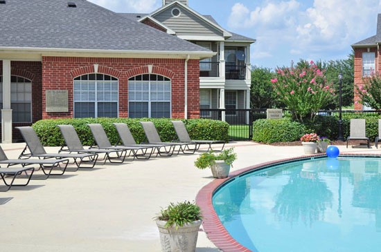 Champion Lake Pool Side View Looking Onto Clubhouse with Pool Side Lounge Chairs
