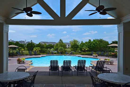 River underneath the pool side arbor with fans and tables/chairs looking at pool