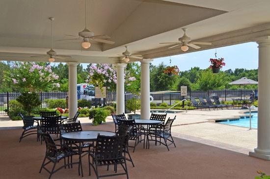 Westlake overhead arbor next to pool with tables and chairs