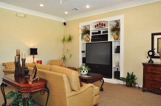 Champion Lake Apartments View of Big Screen in Media Room with Comfortable Lounge Chairs