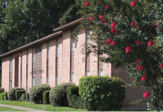Brookwood Apartments Beautiful Side View of Building with a Rose Bush