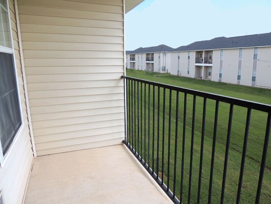 Fox Creek Apartments balcony overlooking large green area separating another buildings