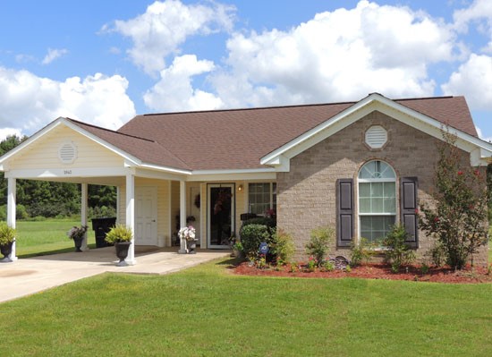 King Oaks Apartments model exterior of big home with overhead parking area