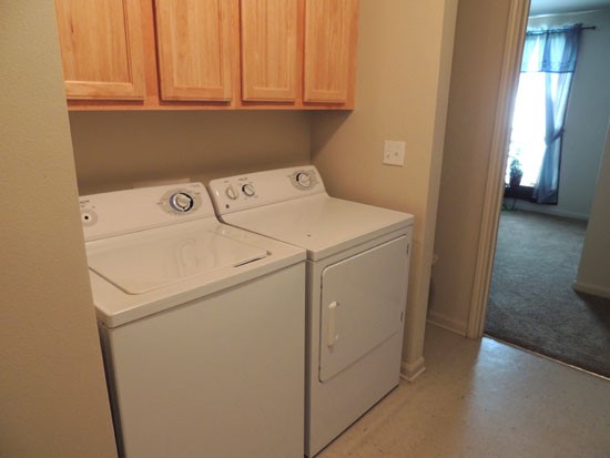 King Oaks laundry room with lots of storage space above