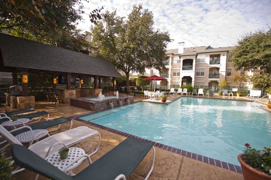 La Crosse view from steps going into pool looking at overhead outdoor kitchen area