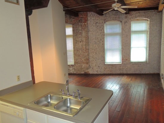 Lee Hard Apartments model kitchen looking into big open model living room, wood floors
