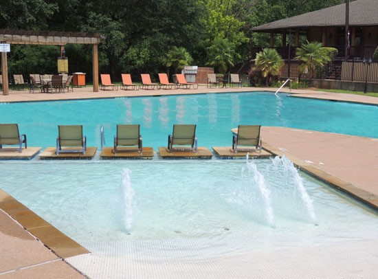 Riverbend Apartments pool fountains, small end, with in pool lounge chairs