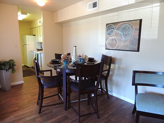 Riverbend big open model dining area with lots of natural light leading into kitchen