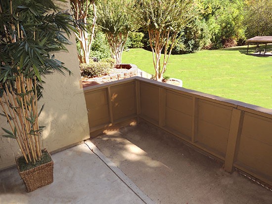 Riverbend Apartments large patio with tons of space and looking at beautiful greenery