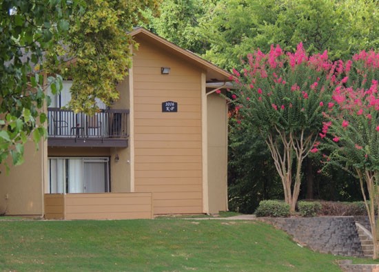 Riverbend backside view of apartments with patios/balconies looking at greenery