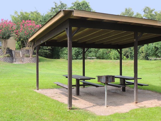 RIverbend Apartments overhead picnic area with two tables and a small grill lots of open grass area