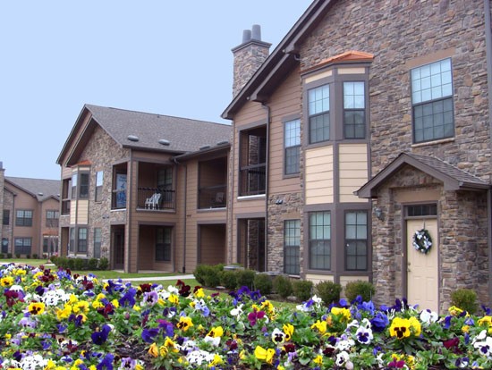 Springridge Apartments up close view at beautiful apartment building with colorful flowers