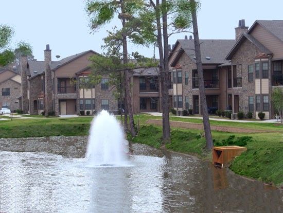 Springridge Apartments lake front view of big lake with water fountain, apartments surrounding