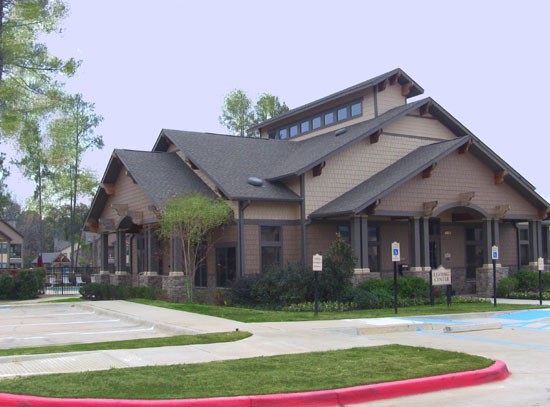 Springridge Apartments exterior of stunning tan and brown clubhouse with own parking lot