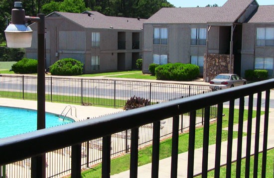 Tree Tops look at gated pool area from balcony looking at other apartment buildings