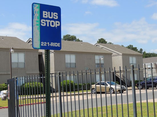 Tree tops Apartments bus stop sign, right outside gated complex