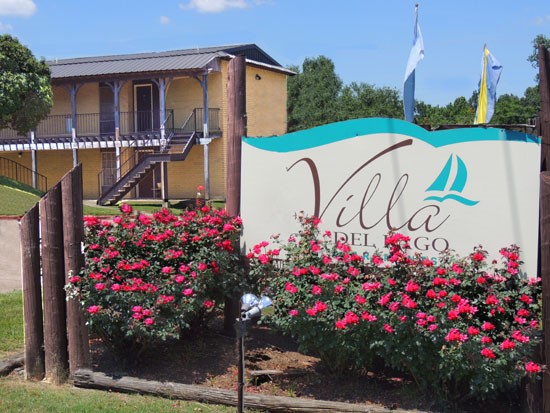 Villa Del Lago Apartments big blue and white front sign leading into apartment complex